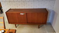 Full front view of closed teak credenza