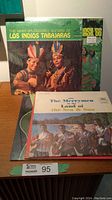 Photo showing multiple vinyl albums standing upright including two by Los Indios Tabajaras, The Merrymen's Land of the Sea & Sun, and ASHL '68