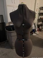 Front view of the black female dress form mannequin with visible adjustment dials on bust, waist, and hip.