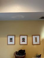 Three framed vegetable-themed prints hung on a wall.