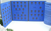 Blue Whitman coin album open showing coin slots arranged by reigns Victoria, Edward VII, and George V for Canadian Silver 5 cent pieces from 1858 to 1921.