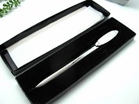 Letter opener inside original black storage box with white padding, showing overall presentation and condition.