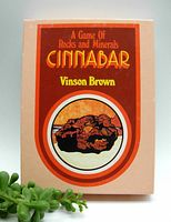 Photo of the game box cover titled 'Cinnabar: A Game of Rocks and Minerals' by Vinson Brown with image of cinnabar mineral.
