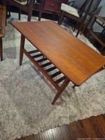 Top and side view of teak end table showing slatted shelf and tapered legs