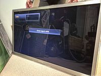 Front view of Samsung UN46C8000 powered on displaying check signal message