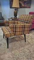 Front angled view of plaid tweed armchair