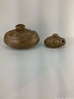 Both vintage ceramic potato shaped serving dishes, large and small, shown side by side on plain background
