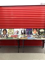 Photo of vintage vinyl records displayed on tables showing album covers from various artists including Richie Havens, Bob Seger, and classic rock bands.