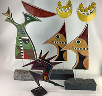 Full view of all four hand-painted metal abstract sculptures against white backdrop