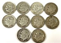 Top view showing the obverse side of ten silver Roosevelt dimes dating from the 1950s and 1960s with visible dates and Roosevelt profiles.