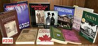 12 books arranged on wooden surface, mostly about Toronto and Canadian subjects with visible titles and different formats