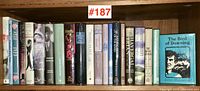 21 vintage hardcover books with dust jackets visible on shelf, titles including art, history and literature books.