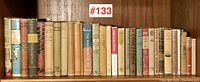 Full shot of 30 vintage hardcover books on shelf with original dust jackets, showing spines and titles, lot #133
