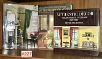 Three books on a shelf, showing their front covers: 'British Tradition and Interior Design', 'An Illustrated History of Interior Decoration', and 'Authentic Decor: The Domestic Interior 1620-1920'. The photo highlights the lot's contents and book titles.
