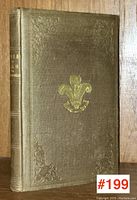 Full front cover view of antique book with gilt emblem and textured brown cloth binding, showing overall condition and design.