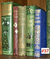 Five Victorian hardcover books with colorful decorative bindings and embossed designs, titles visible from spine and front covers.