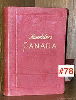 Photo of the front cover of the Baedeker's Canada 1907 travel guide showing the red hardcover with gold embossed title.