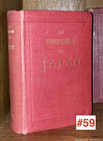 Front cover of the book showing red cloth cover with title 'An Official Guide to Japan' embossed in gold lettering.