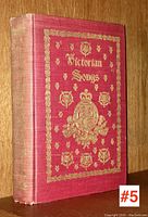 Side view of the book showing spine and some wear, the spine gold text partially faded.