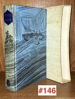 Front and spine view of the boxed edition of Moby Dick showing covered slipcase and the book with nautical cover art.