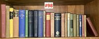 Shelf containing 23 vintage books, showing varied colors and sizes, arranged tightly tightly together with label #98 above.