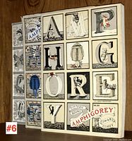 Three Amphigorey paperbacks on wooden shelf showing front covers