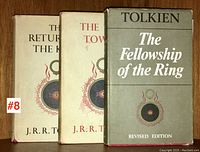 Three volumes upright on shelf showing spines and front covers