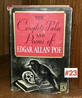 Front cover of the book showing the dust jacket with black and red design featuring a crow and skull on an open book, title clearly visible.