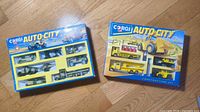 Both boxed Corgi Auto City sets side by side on floor
