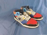 Side view of both Champion 90s Throwback sneakers showing multicolour uppers and soles