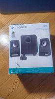 Front of retail box showing Logitech branding, model Z213, speaker images, power ratings