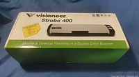 Front of retail box showing Visioneer Strobe 400 image and branding