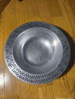 Top view of pewter fruit bowl showing entire rim pattern and interior well