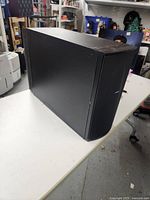 Side diagonal view showing black casing and overall condition of Bose PS28 II subwoofer