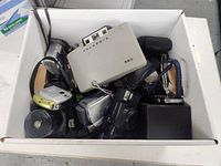 Box containing Polaroid 320, compact digital cameras, flash unit and cases