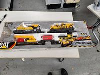 Front view of sealed CAT Construction Express Train box showing all components inside through plastic window