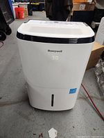 Front view of white Honeywell dehumidifier showing digital display reading 30