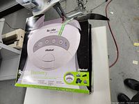 Closed original box showing image and branding of Roomba Discovery robotic vacuum