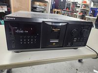 Front view of Sony CD player powered on showing disc 1 on display with main buttons and control dials.
