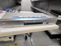 Front angle view of silver Sony DVD player with HDMI label and disc tray.