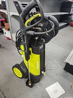 Full side view of the Sun Joe 2030 PSI electric power washer showing handle, wheels, and hose reel.