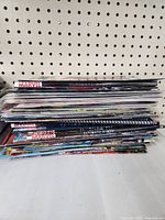 Stack of X-Men comics viewed from side showing multiple issues and Marvel branding.
