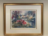 Photo of the framed watercolor landscape painting showing autumn foliage, buildings, water, and sky in colorful detail.