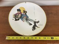 Front view of the Rockwell Plate with a measuring tape showing approx. 12 inches diameter.