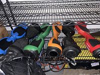 Photo showing six hoverboards of different colors placed on a metal shelf. They are untested and sold without chargers.