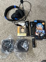 Lot items including headset, flashlights, Dwight Schrute mini, iPhone 5s case, and speakers