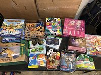 Photo of all new boxed puzzles, games, and toys arranged on a table showing various brands and types.