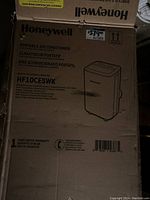 Closed Honeywell portable air conditioner box with model number and specs on side.