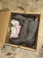 Side and top view of the pair of Sugar women's boots in a box showing brown leather and textured fabric design.