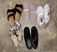 Top-down view of five pairs of women's shoes, all size 9, arranged on concrete floor